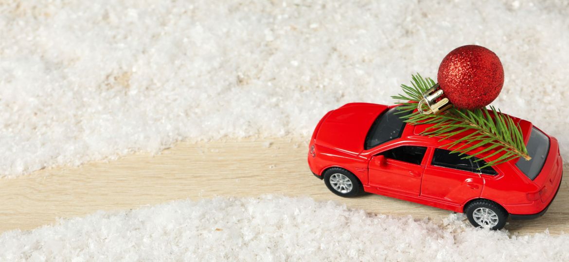 A car with a Christmas tree and New Year's decor.