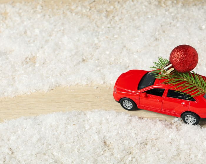 A car with a Christmas tree and New Year's decor.