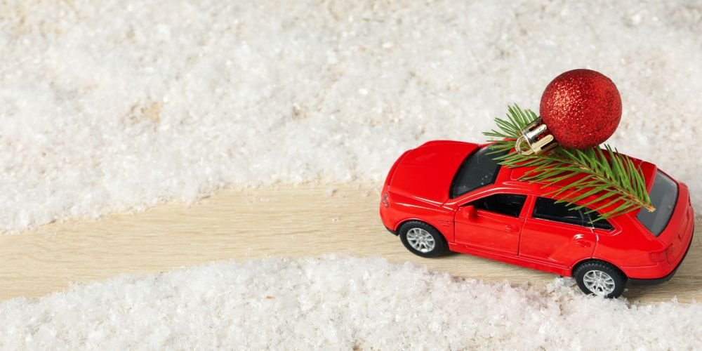 A car with a Christmas tree and New Year's decor.