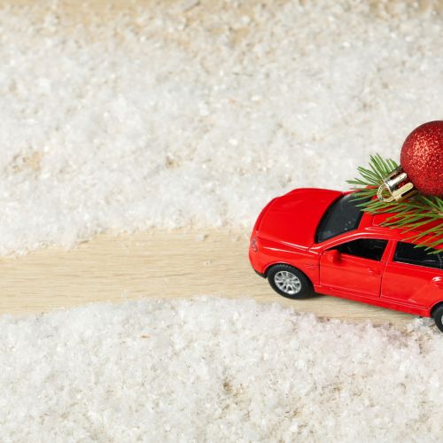 A car with a Christmas tree and New Year's decor.