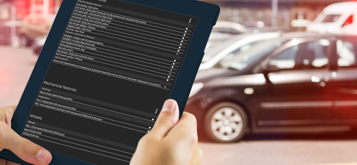 Man using tablet pc against view of row new car