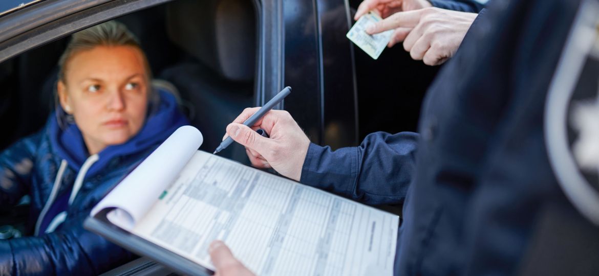 Police patrol checking driver's license of driver